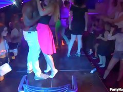 Naughty girls are taking turns sucking a handsome dancer's dick and getting fucked in the night club