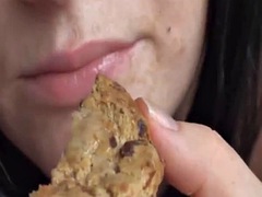 Chubby brunette milks a cock and eats a cookie covered in cum